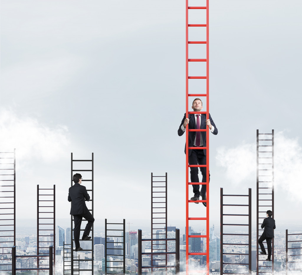 businessmen climbing up the ladder