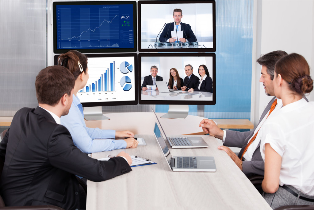 a virtual business training with employees sitting on a desk