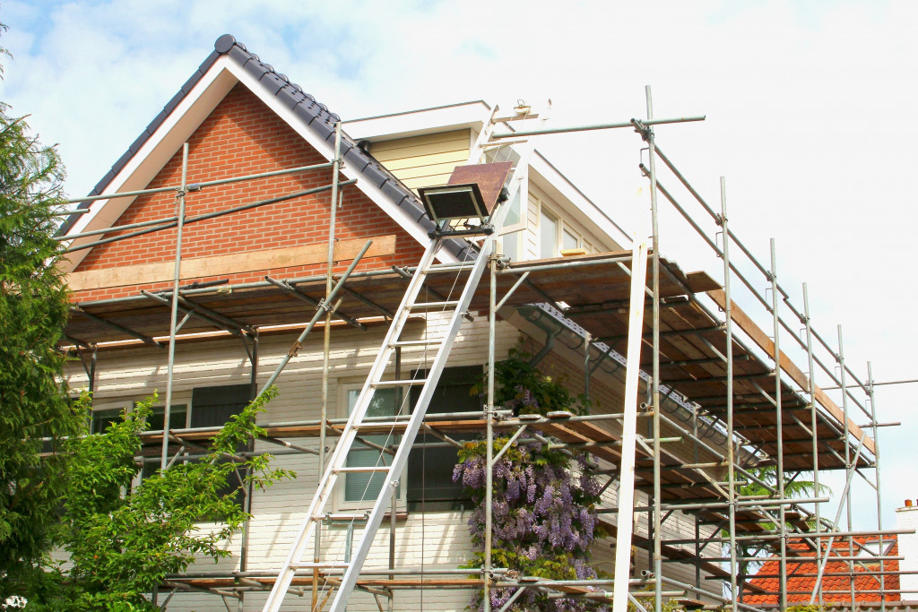 house with many structural ladders and wood to represent renovation