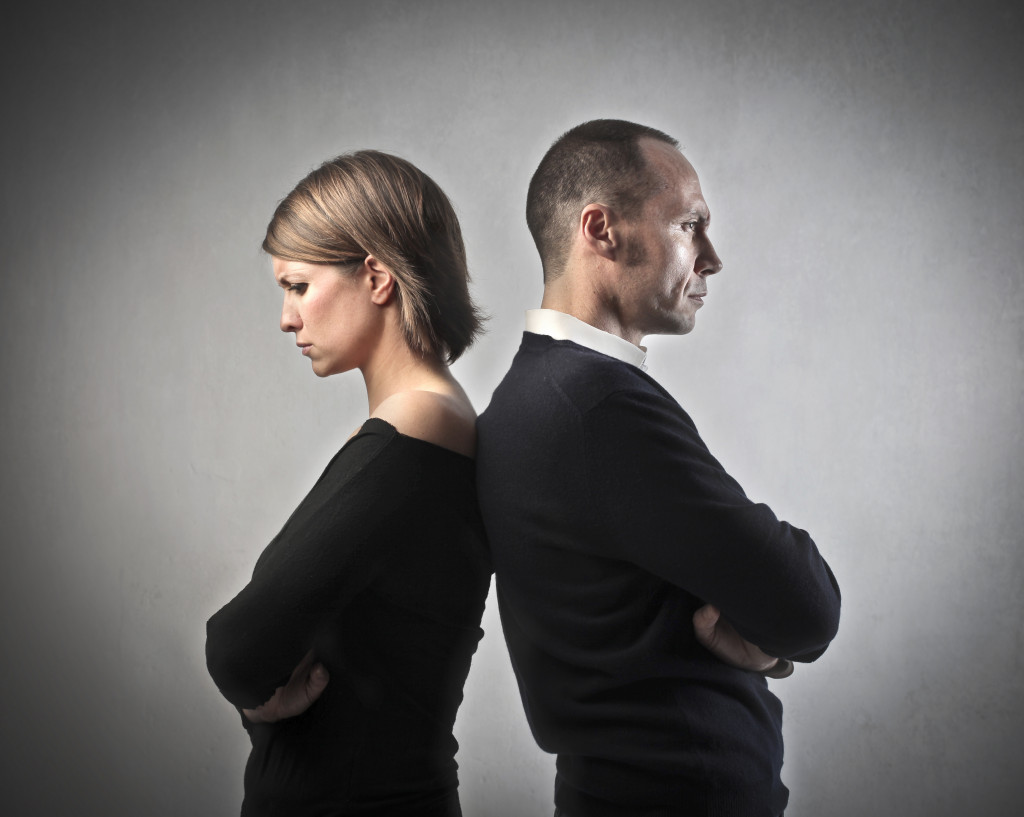 businessman and wife with backs turned to each other representing divorce