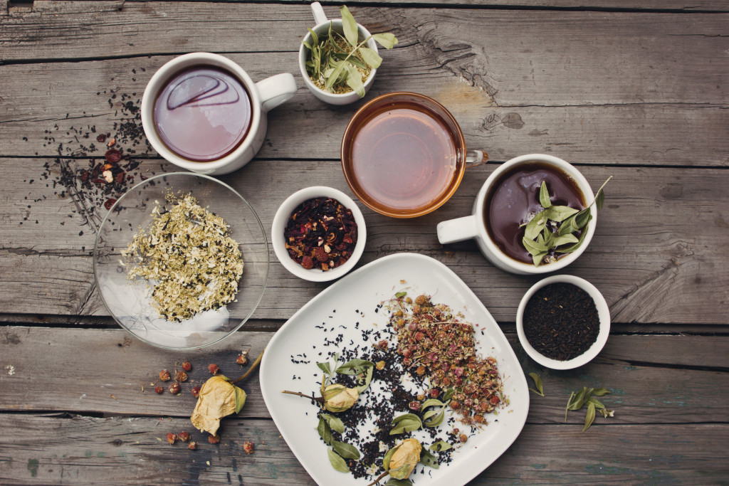 artisanal teas and herbs scattered in a wooden table