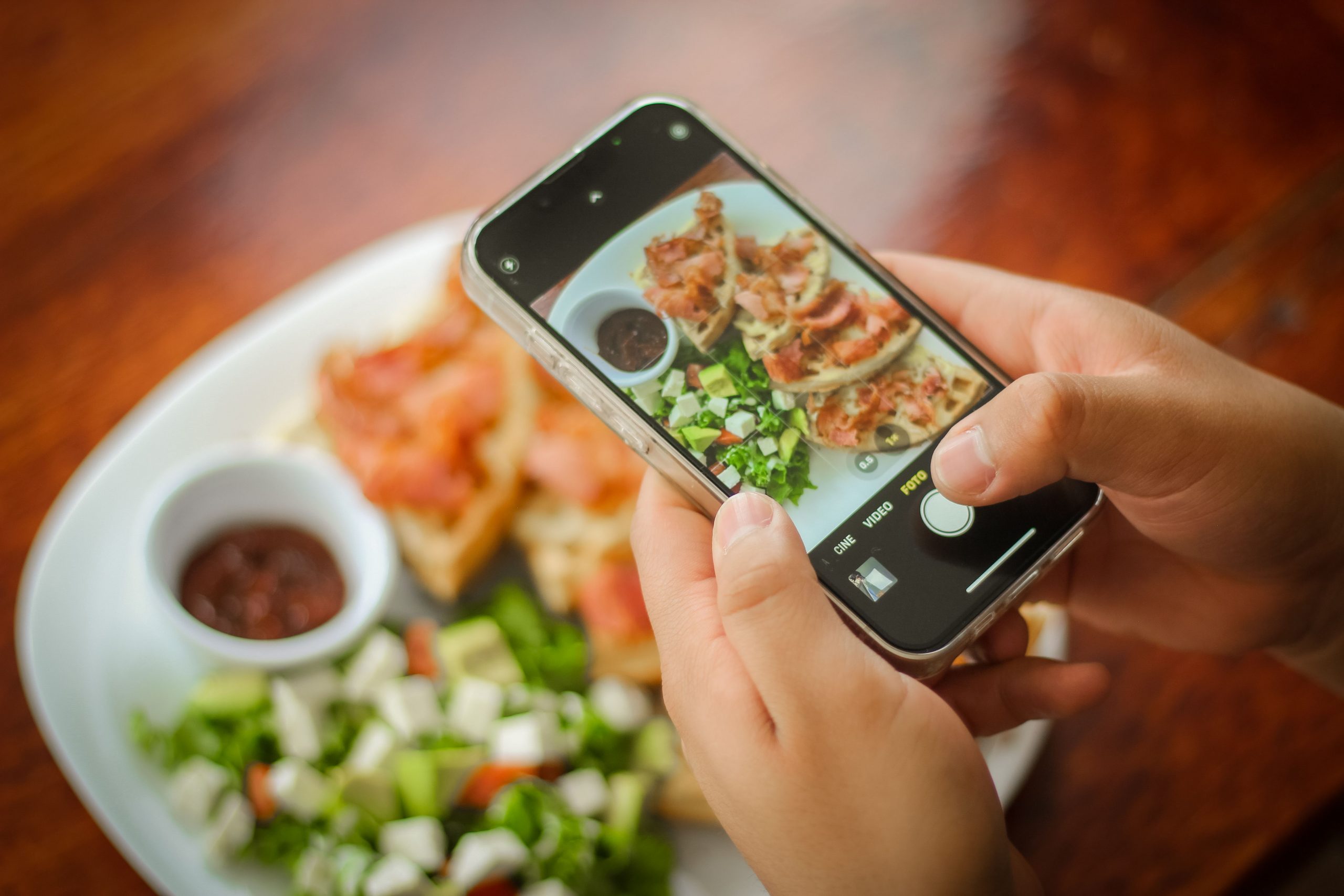 person taking a photo of food