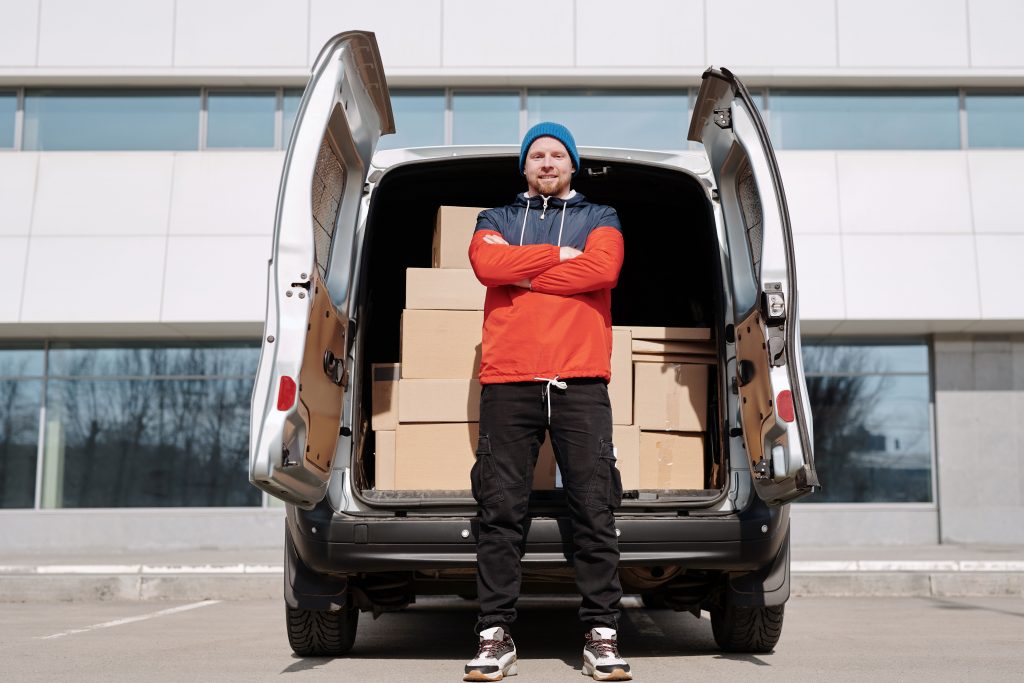 deliveryman standing in front of a truck