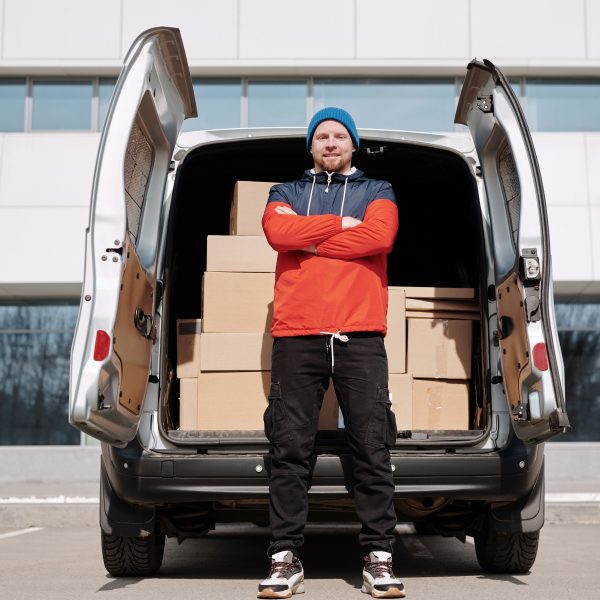 deliveryman standing in front of a truck